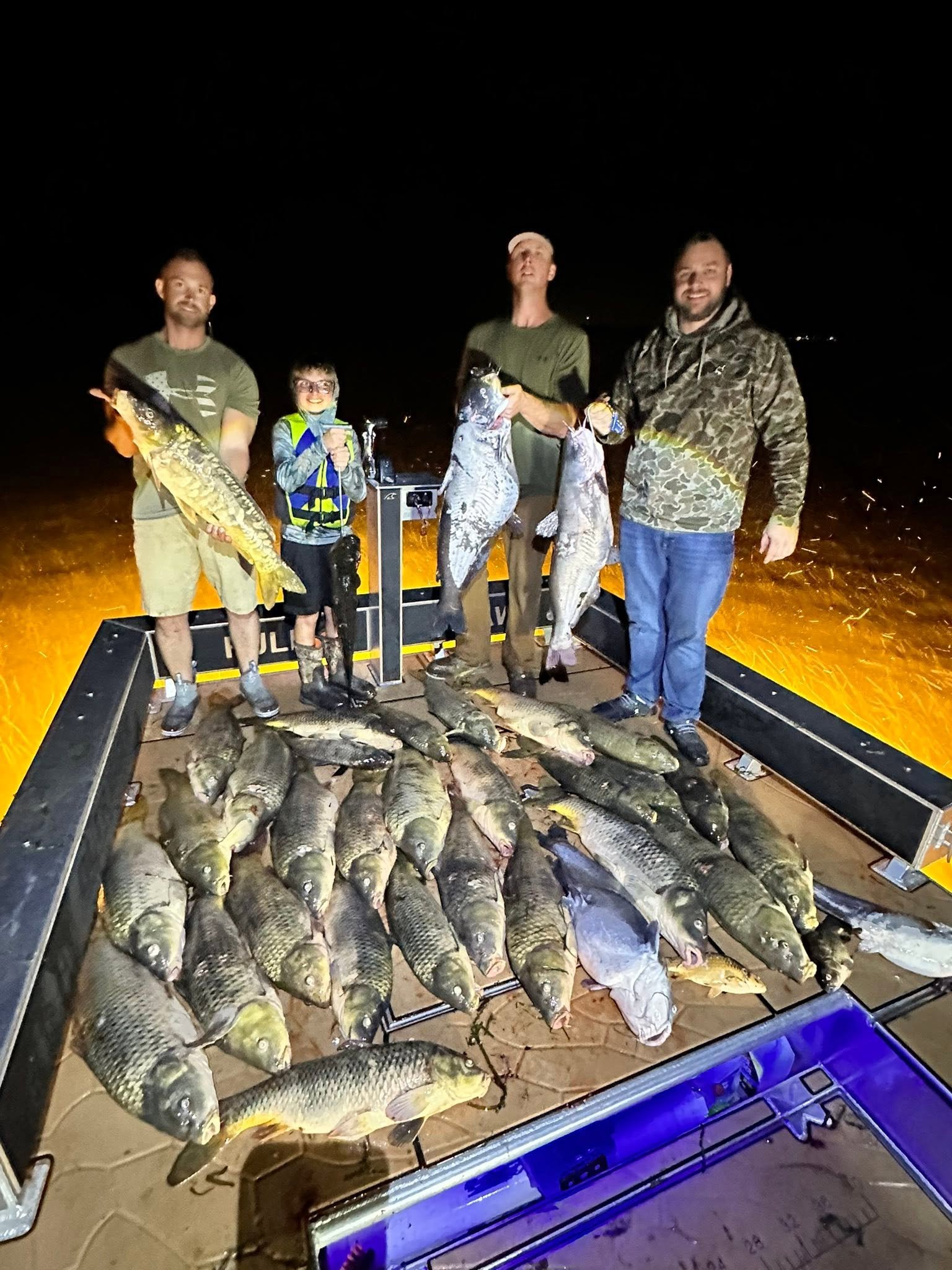 Angler holding a large carp caught bowfishing